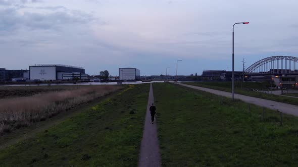 Man Walking On Strolling Path Inside Crezeepolder In South Holland. aerial alt