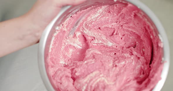 Cooking Food And People Concept Chef With Spatula Stirring Pink Buttercream alt