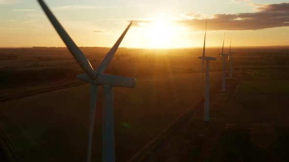 Four wind turbines at sunrise