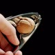 Male hand crushing a walnut with a steel nutcracker. Slow motion - VideoHive Item for Sale