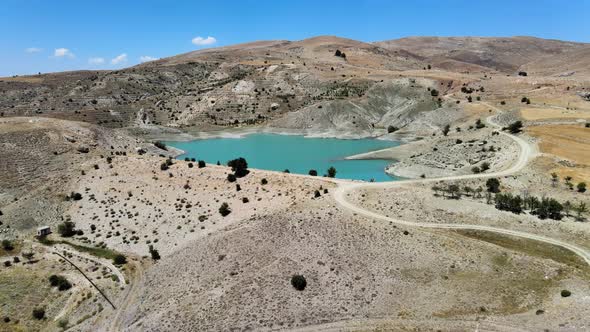 Drone shooting of a small mountain lake with turquoise water in Turkey alt