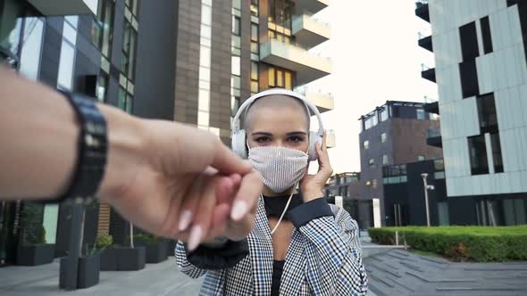 Cinematic video of an happy bald girl listening to music alt