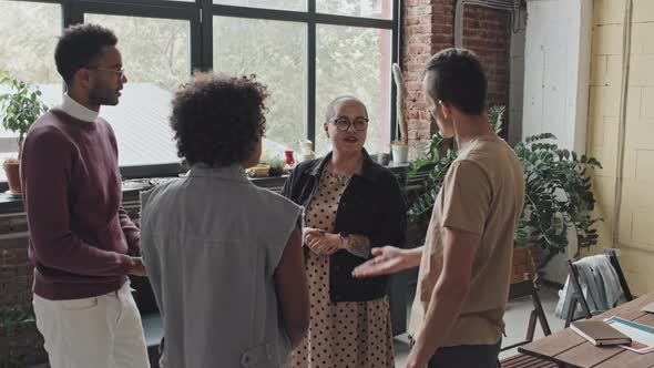 Diverse Colleagues Chatting in Modern Office alt