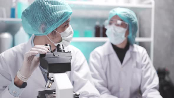 Scientist team has researching in the laboratory microscope and analysis results in the laboratory alt