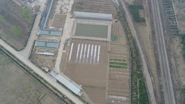 Rural poor village outside Beijing with farmland and train tracks during extreme pollution day alt