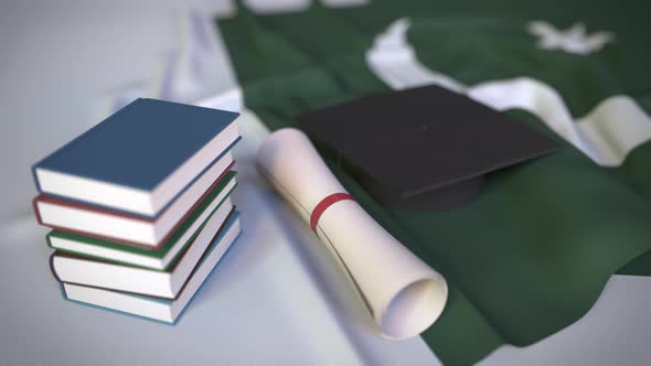 Graduation Cap and Diploma on the Flag of Pakistan alt