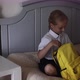 Cute Caucasian Primary School Girl Wearing Uniform and Packing Backpack at Home on Bed Kid Preparing - VideoHive Item for Sale