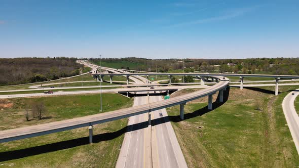 Following Aerial Speeded Shot of a Sunny Busy Traffic Highway Interchanges alt