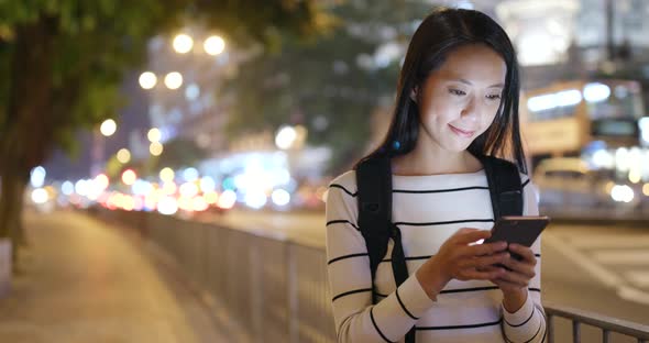 Woman Use of Smart Phone in City at Night 