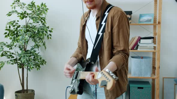 Slow Motion Portrait of Carefree Musician Playing Electric Guitar Enjoying Creative Activity in alt