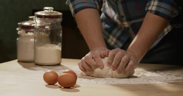 Male Hands Knead Dough From Flour at Home