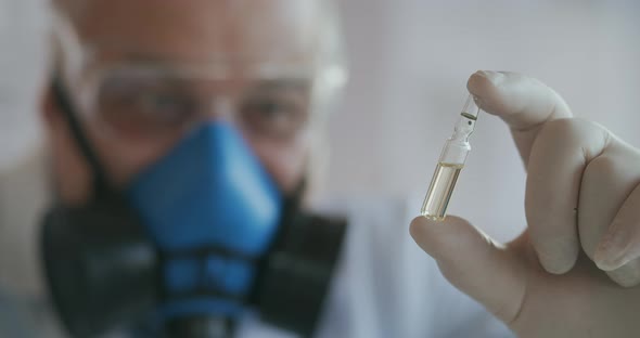 Extreme Close-up of a Scientist in a Blue Respirator and Protective Glasses, the Developer of the alt