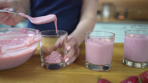 Transfers Strawberry Pudding to Serving Glasses