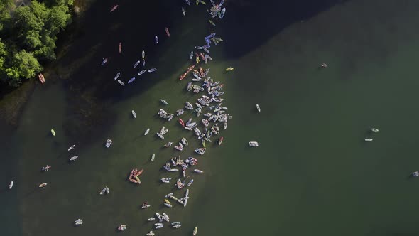 Aerial view above a group of SUP boarders on the Colorado river in Austin, USA - rotating, top down, alt