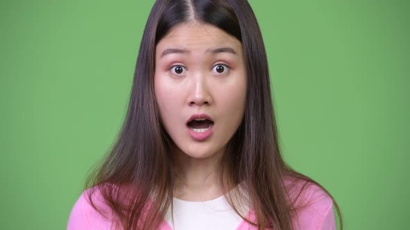Young Beautiful Asian Woman Looking Shocked