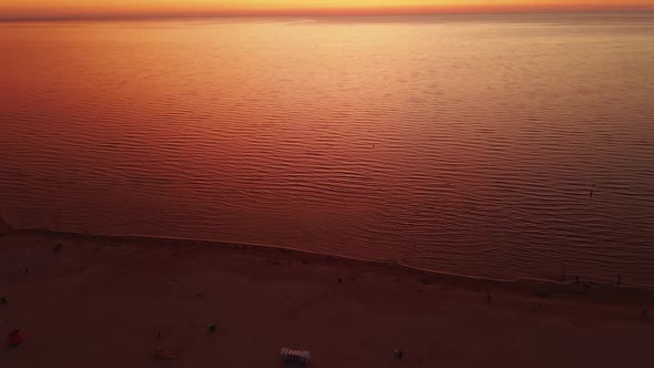 Unreal Orange Aerial Parralax Pan Up Over Fantastic Sky During Amazing Orange and Red Sunset alt