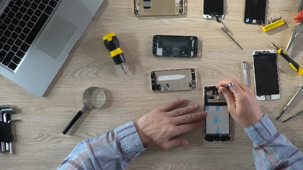 Man Repairing Broken Gadget, Diagnosing Mobile Phone Problems, Service Center alt