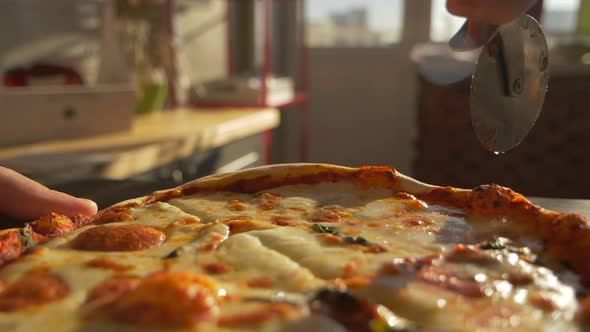 Macro Filming of Pizza Pie Slicing Into Pieces with Special Knife By Chef Cook