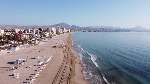 Aerial overview of beach and coastal town in the Mediterranean. Playa de Muchavista, El Campello, Sp alt