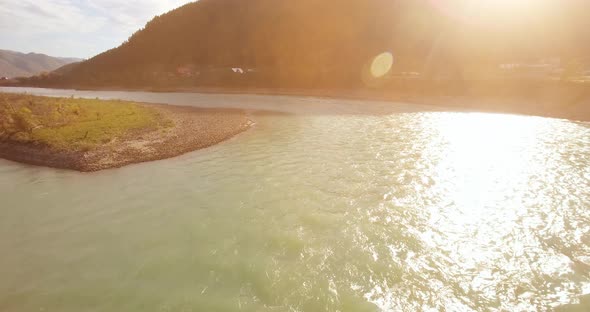 Low Altitude Flight Over Fresh Fast Mountain River with Rocks at Sunny Summer Morning. alt