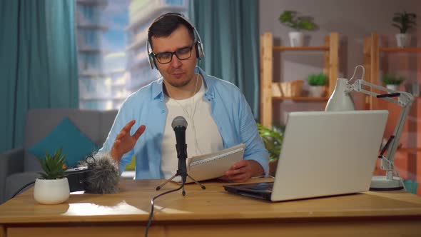 Man Records an Audio Podcast or Conducts an Internet Stream While Sitting at Home alt