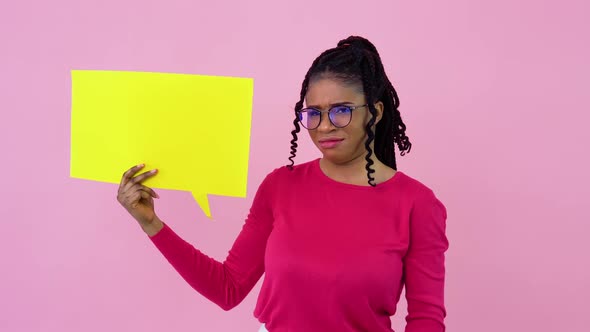 Cute Young African American Girl Stands with Posters for Expression on a Solid Pink Background alt