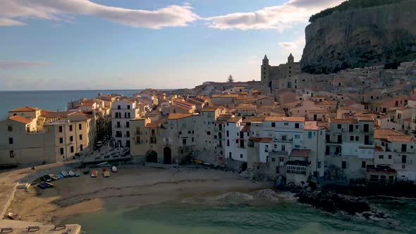 Cefalu Sicily Sunset at the Beach of Cefalu Sicilia Italy Mid Age Men and Woman on Vacation Sicily alt