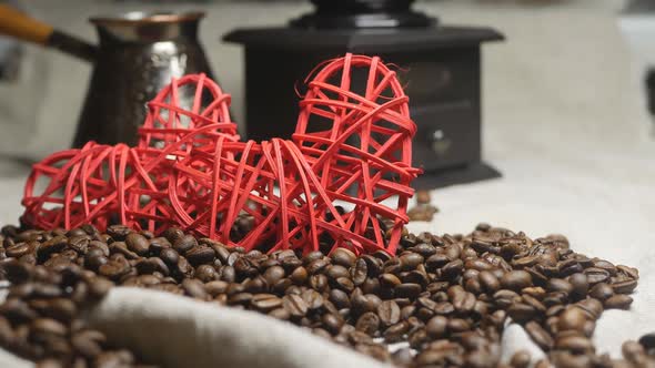 Two Red Hearts Made of Straw on Coffee Beans and Fabric