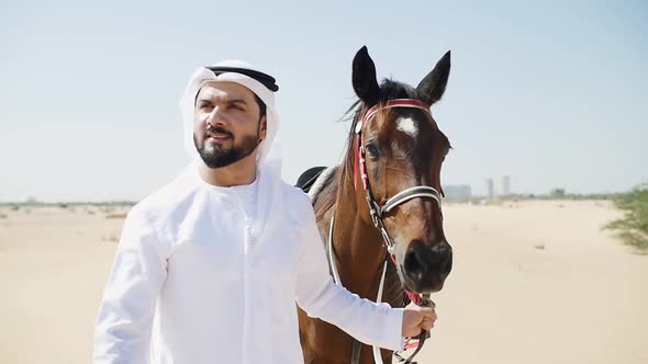 Arabian man with his horse alt