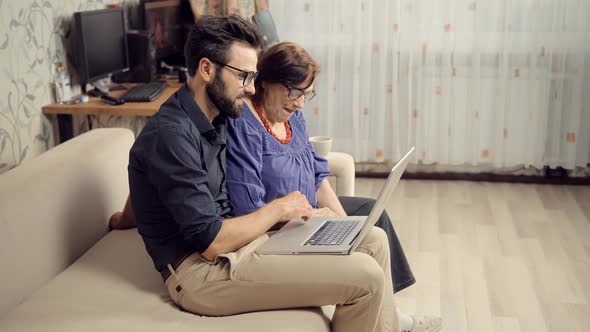 Senior Woman Watch Internet Websites With Son. Family Relationship Online Chatting Social Network. alt