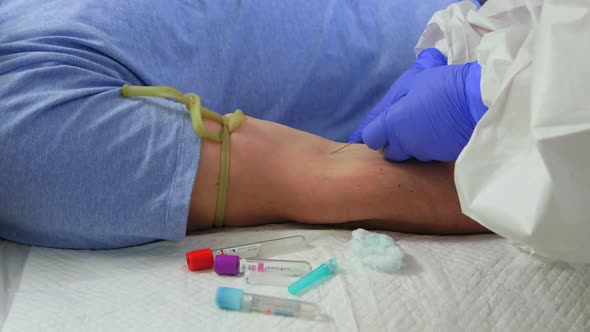 Close-up of hand of man giving blood for biochemical covid-19 blood testing at his home.