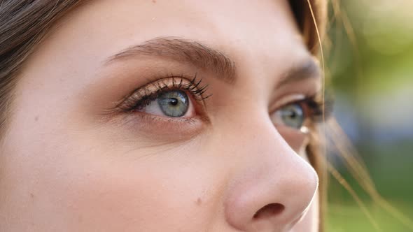 Close up of Woman's Face Girl Opening Her Beautiful Blue Eyes