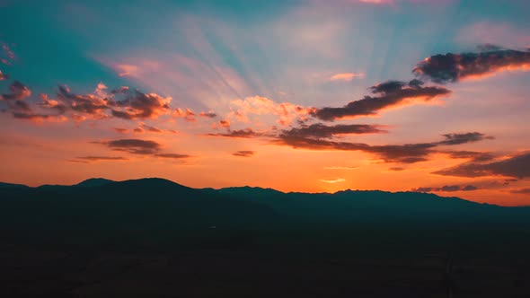 Aerial drone shot of sunset over mountains