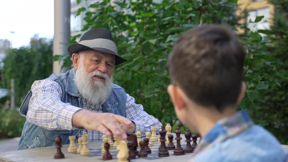 Senior Male Chess Master Teaching Chess Strategy alt