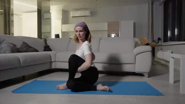 Young Flexible Girl Performs Exercise to Stretch Muscles of the Body