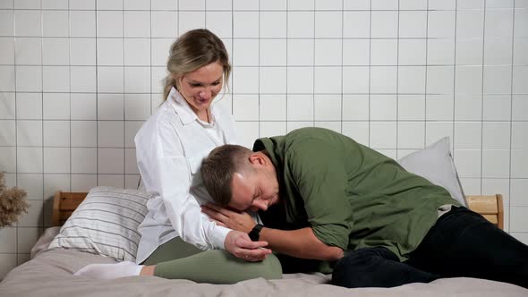 Man Leans on Pregnant Woman Tummy and Listens to Child Move alt