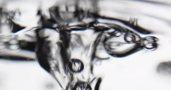 Bubbles Rising To A Moving Surface Of Water And Popping alt