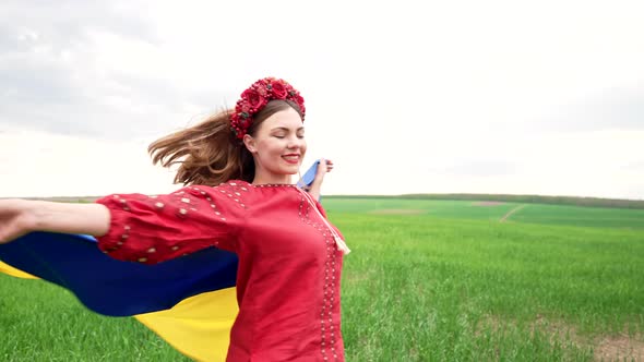 Happy Ukrainian Woman Spinning Around with National Flag on Sky Background alt