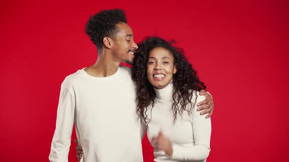 Portrait of young african american couple on red studio background. Love concept alt