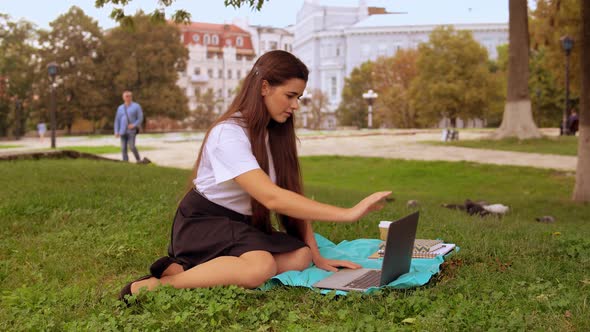 Attractive Girl Using Computer Outdoors alt