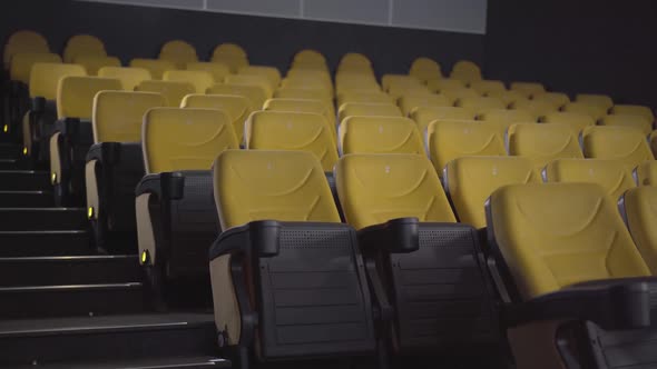 Wide Shot of Empty Cinema Hall with Rows of Yellow Chairs. No People in Movie Theatre. Luxurious alt
