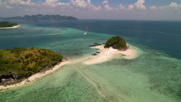 aerial drone circling Thale Waek Island in the Andaman sea surrounded by coral reefs and turquoise b alt