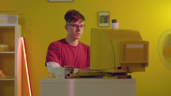 Young IT Professional Is Working at Computer