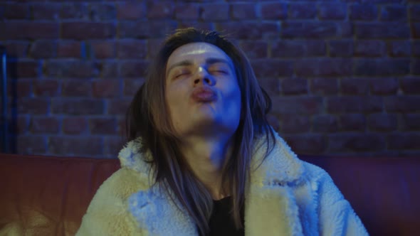 Relaxed Man Taking Lsd Blotter in Nightclub To Enjoy Euphoric Effect alt