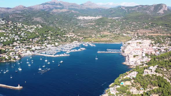 Port Andratx in Mallorca Spain with lighthouse point below on sunny day, Aerial panorama pan left vi alt