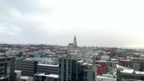 Drone Flight Over City Buildings In Reykjavik, Iceland With Distant View Of Hallgrímskirkja, Luthera alt