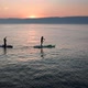 Stand Up Paddle Board Silhouette of Two Women on Water Slow Motion Aerial SUP - VideoHive Item for Sale