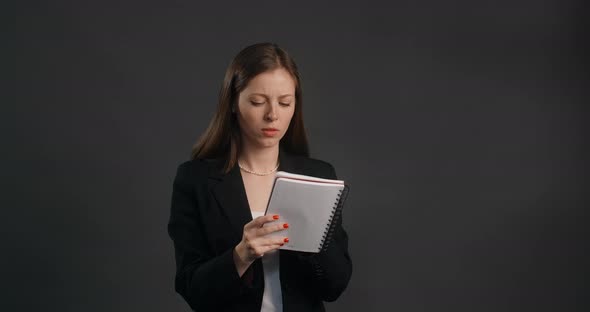 Vexed and Angry Woman in Black Suit Crosses Out Hes Notes in the Notepad Crumples Sheet of Paper and alt