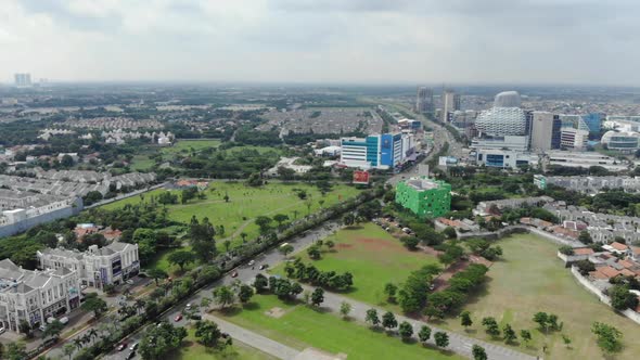 Aerial view of a small city with green areas