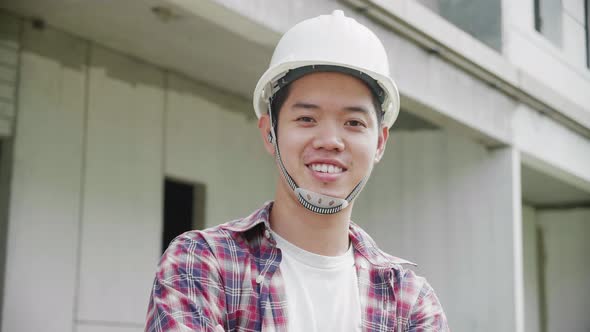 Young Asian construction site engineer,close up.